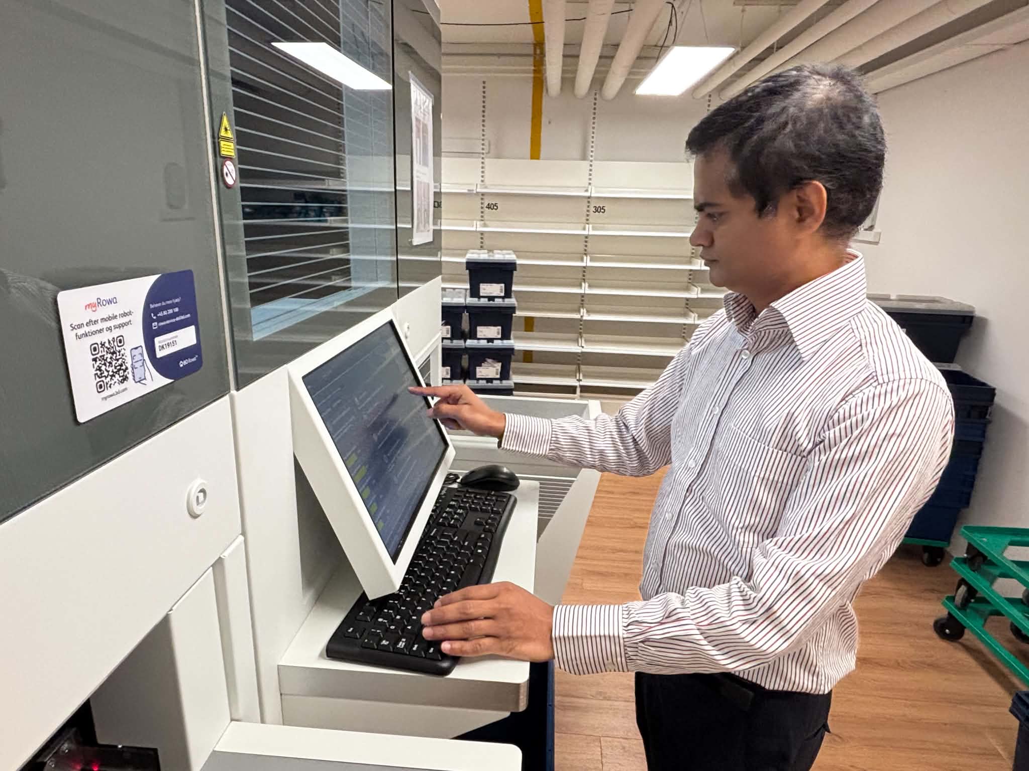 Prasad Reddy med den store lagerroboto, som skal gøre ekspeditionerne hurtigere og frigøre personalet til at yde personlig service.